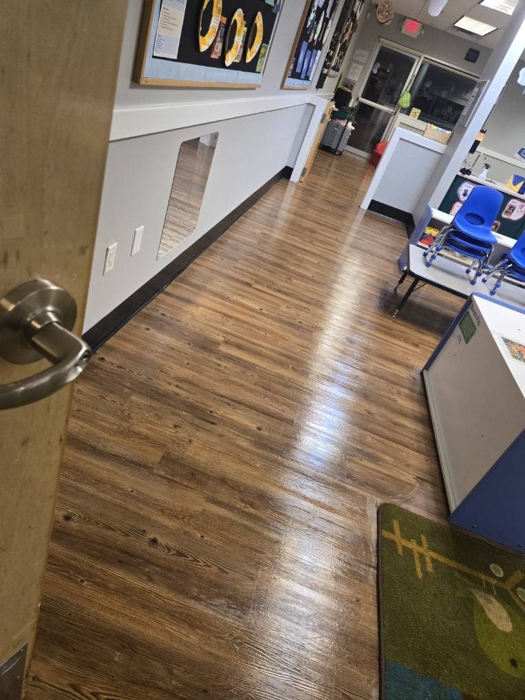 Daycare hallway with freshly waxed wood-look flooring cleaned by AICS