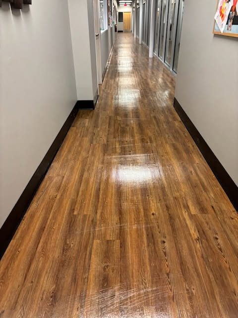 Hallway floor stripped, waxed and buffed to a high gloss by AICS